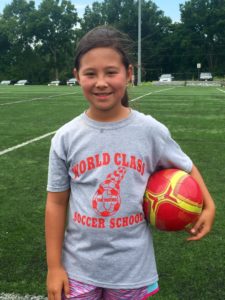 Image of Young Asian Girl with Red Soccer Ball - World Class Soccer School - Pennsylvania
