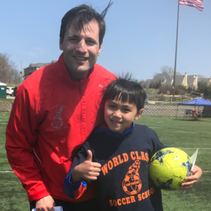 Image of Nicholas Nico Severini and a young boy camper with his thumbs up - World Class Soccer School Pennsylvania